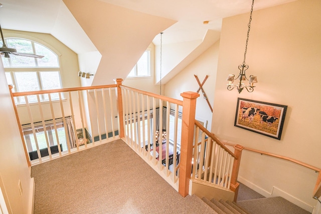 staircase with carpet floors, high vaulted ceiling, and a chandelier