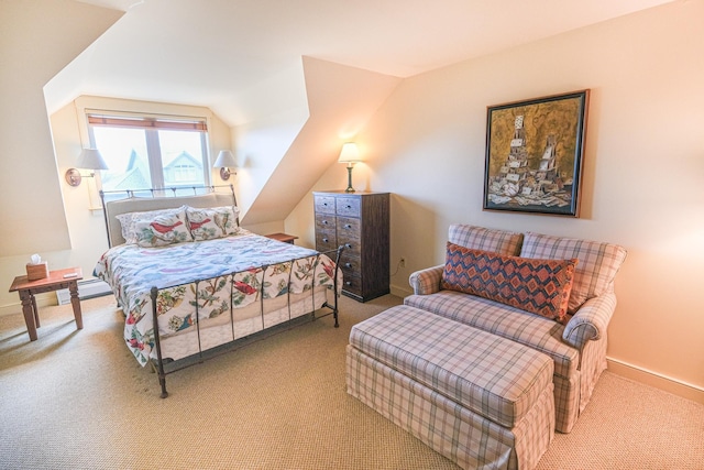 carpeted bedroom with lofted ceiling