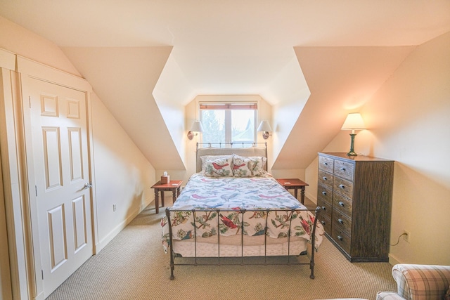 carpeted bedroom featuring lofted ceiling