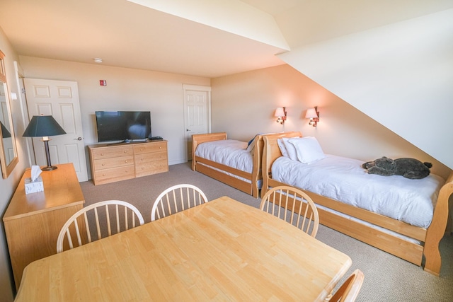 bedroom featuring carpet floors and vaulted ceiling