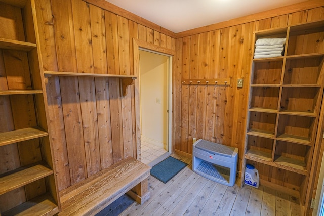 mudroom featuring wooden walls and light hardwood / wood-style floors