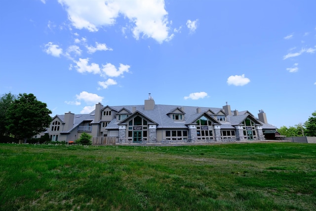 rear view of property with a yard