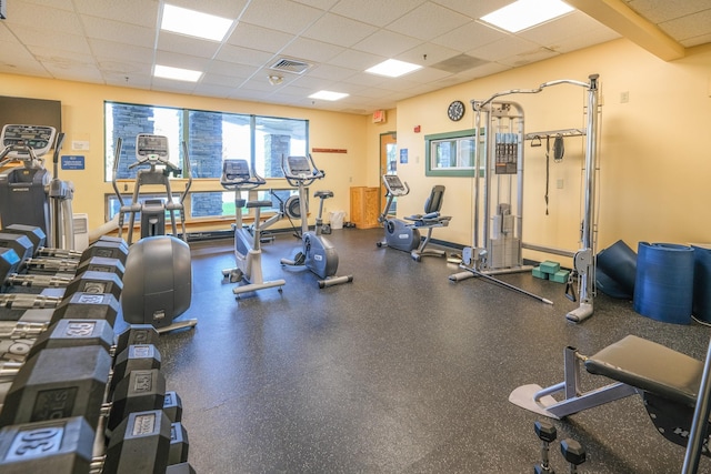 gym with a paneled ceiling