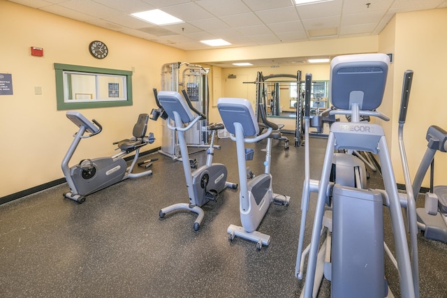 gym with a paneled ceiling