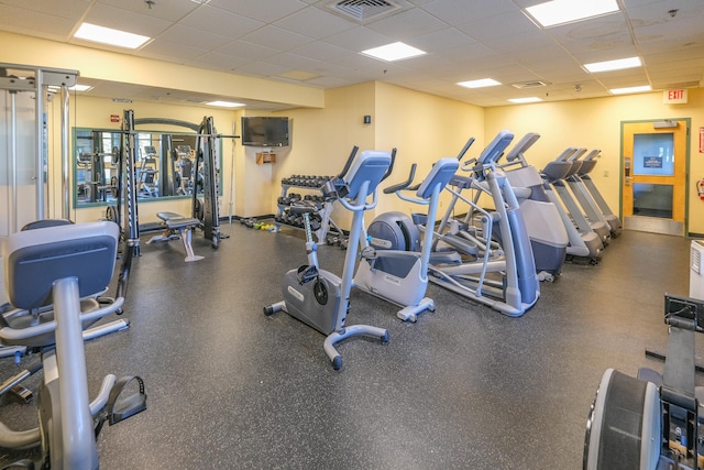 exercise room featuring a paneled ceiling