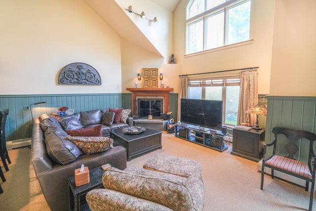 carpeted living room with high vaulted ceiling and a baseboard radiator