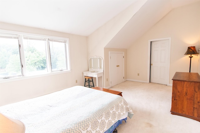 carpeted bedroom with vaulted ceiling