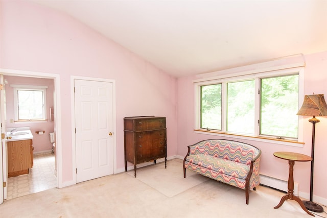 sitting room with sink, vaulted ceiling, light colored carpet, and a baseboard radiator