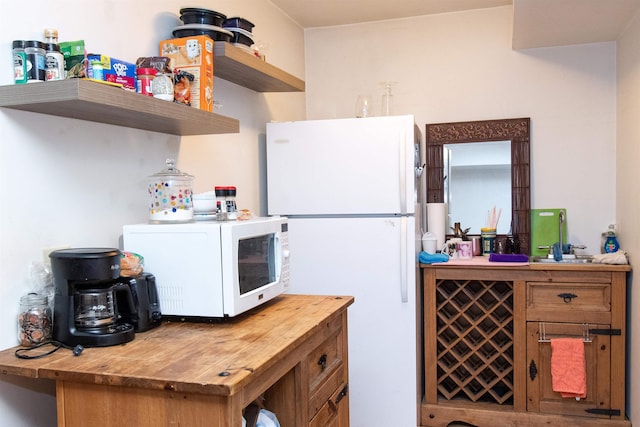 kitchen with white appliances and wooden counters