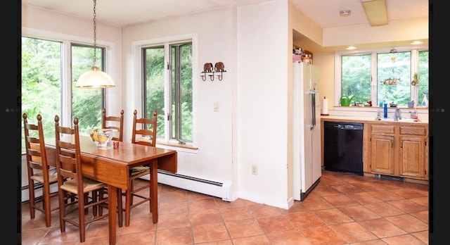 dining room with a baseboard radiator, light tile patterned flooring, and indoor wet bar