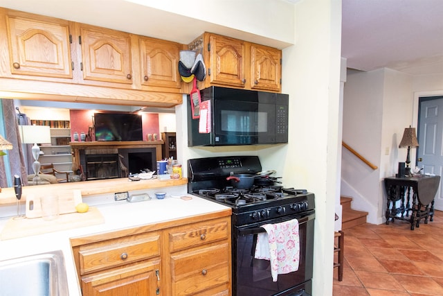 kitchen with light tile patterned floors and black appliances