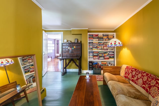 living area featuring crown molding, wood finished floors, and baseboards