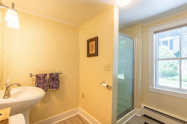 full bathroom with a baseboard heating unit, wood finished floors, a stall shower, and wallpapered walls