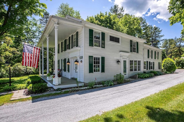 colonial home featuring covered porch