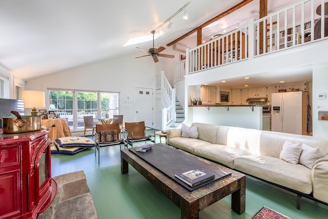 living area featuring high vaulted ceiling, wood finished floors, stairway, rail lighting, and ceiling fan
