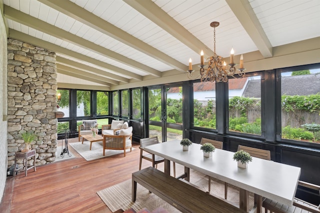 sunroom / solarium with vaulted ceiling with beams, a wealth of natural light, and an inviting chandelier