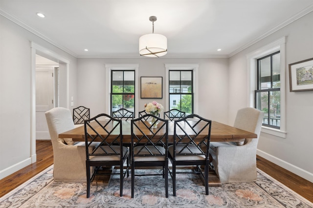 dining area featuring hardwood / wood-style flooring and crown molding