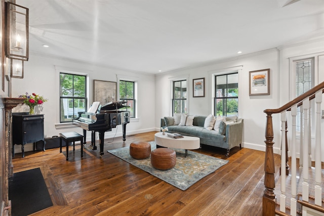 living room with a wealth of natural light, ornamental molding, and hardwood / wood-style flooring