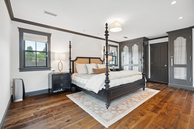 bedroom featuring crown molding and dark hardwood / wood-style floors