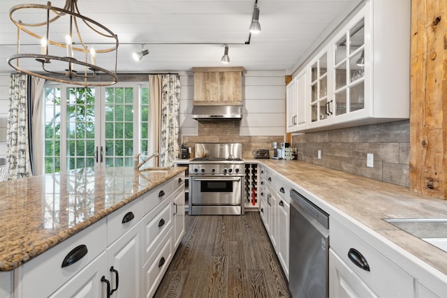 kitchen featuring white cabinets, appliances with stainless steel finishes, and tasteful backsplash