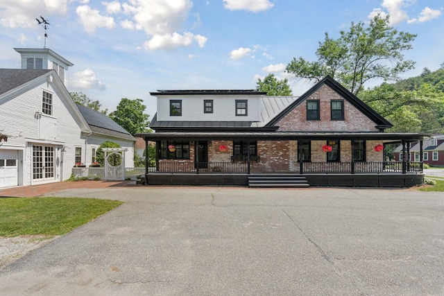 view of front facade featuring covered porch and french doors