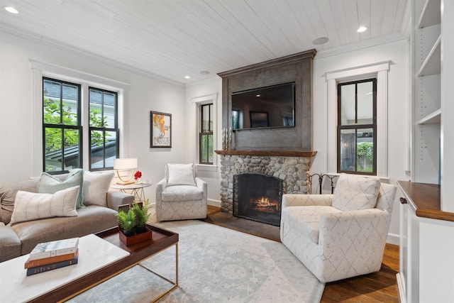 living room featuring a fireplace, hardwood / wood-style floors, ornamental molding, and wood ceiling