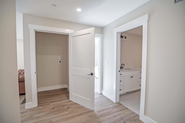 hall with sink and light hardwood / wood-style floors