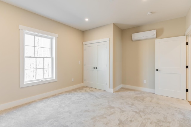 unfurnished bedroom with an AC wall unit, light colored carpet, and a closet