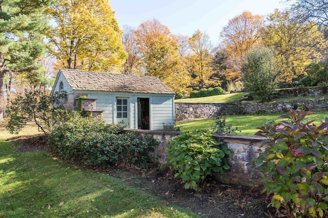 view of outbuilding featuring a yard