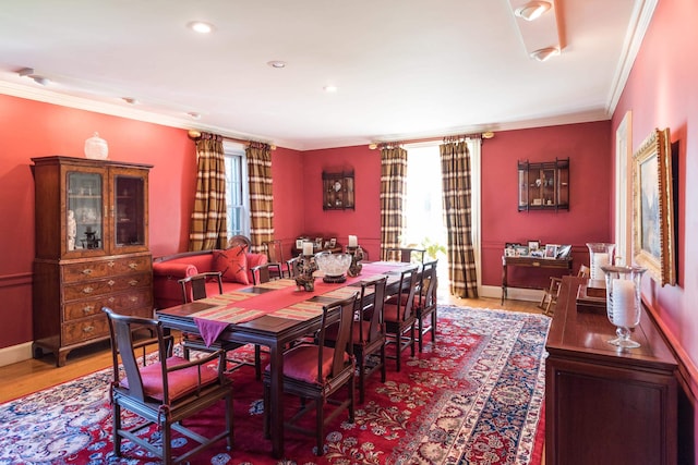 dining room with crown molding and hardwood / wood-style flooring