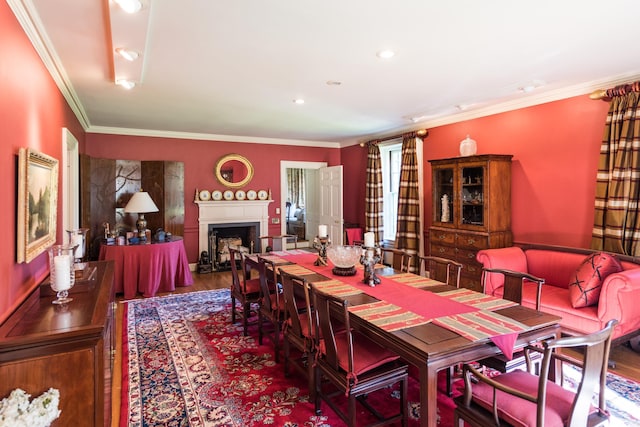 dining area with hardwood / wood-style flooring and ornamental molding