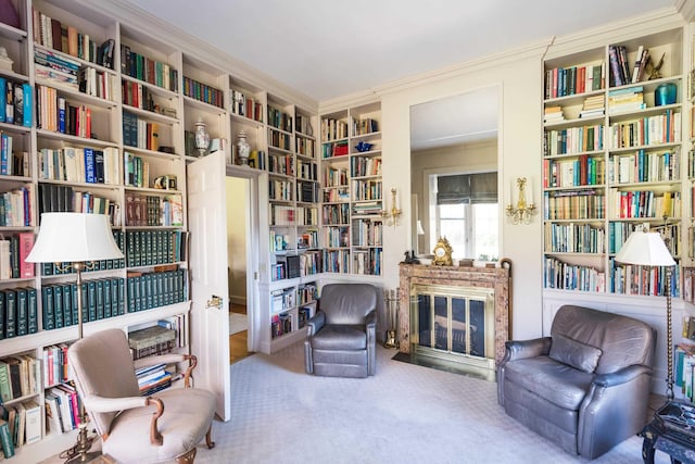 sitting room with carpet floors and ornamental molding