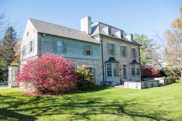 back of house featuring a yard and a patio