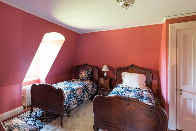 bedroom with crown molding, radiator, and carpet flooring