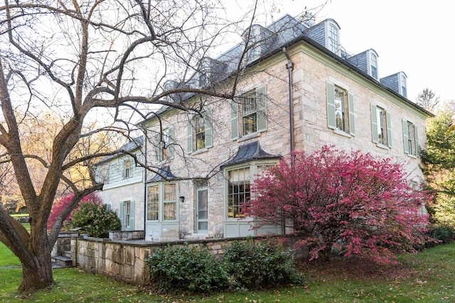 view of side of home with a lawn