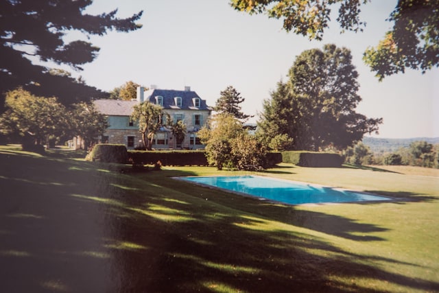 view of pool featuring a lawn