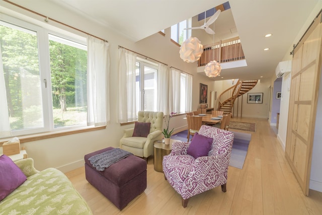 interior space featuring a barn door, plenty of natural light, and a wall mounted AC