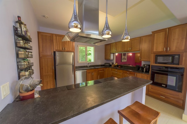 kitchen featuring a kitchen bar, pendant lighting, kitchen peninsula, and black appliances