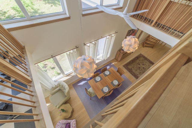 living room featuring wood-type flooring and a towering ceiling