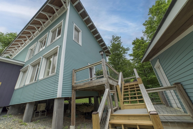 view of side of property featuring a wooden deck