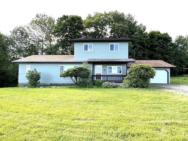 view of property with a garage and a front lawn