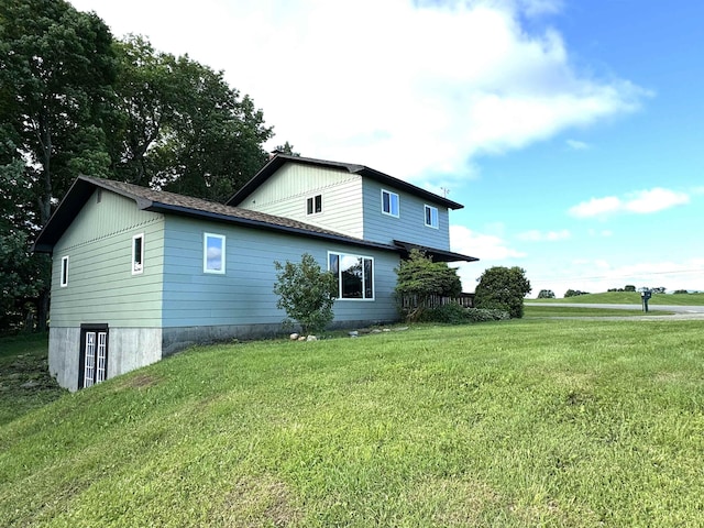 view of property exterior with a lawn