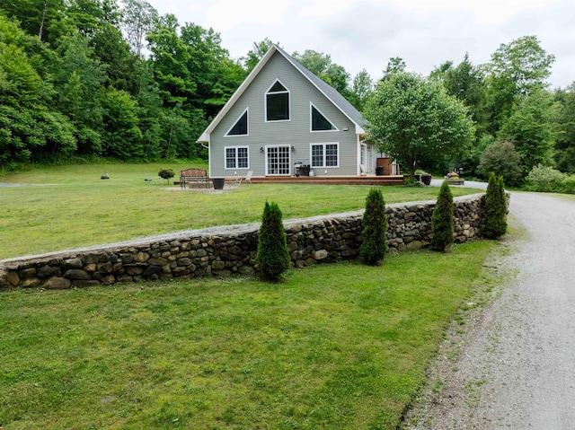 view of front of house featuring a deck and a front yard