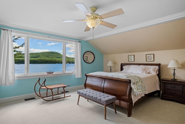 carpeted bedroom with multiple windows, a water view, ceiling fan, and crown molding