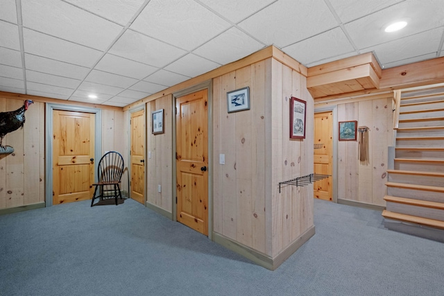 interior space with recessed lighting, stairway, carpet, and wooden walls