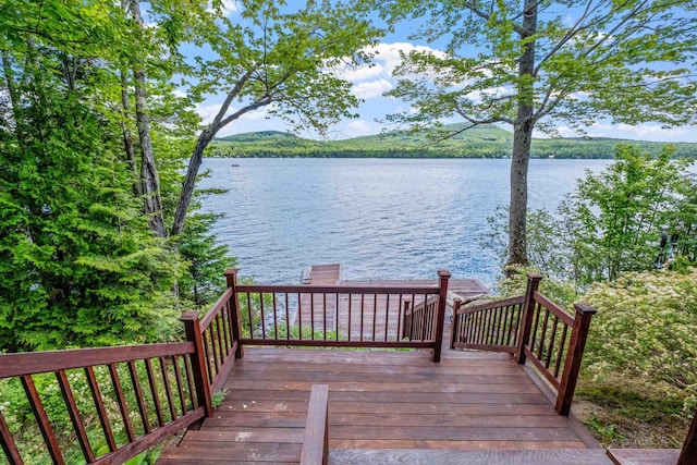 wooden deck featuring a water view