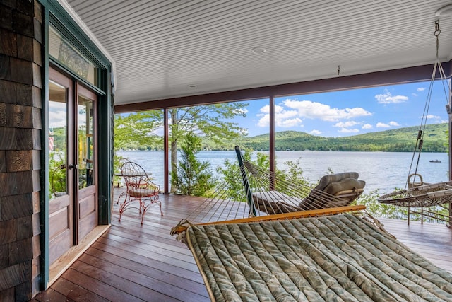 unfurnished sunroom with a water view