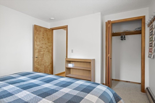 unfurnished bedroom featuring baseboards, a baseboard radiator, a textured ceiling, carpet flooring, and a closet