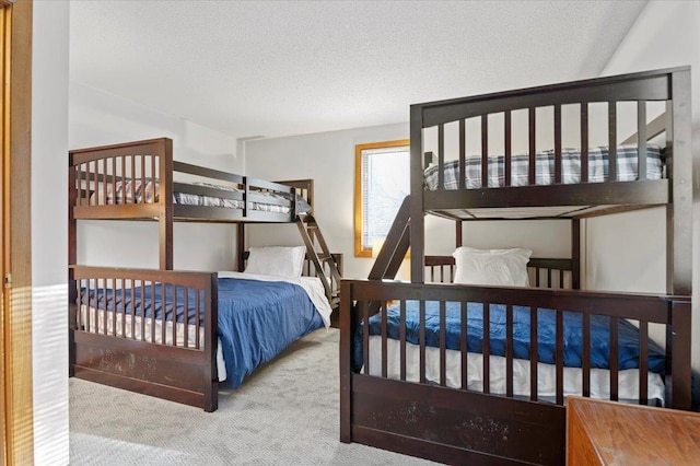 carpeted bedroom with a textured ceiling