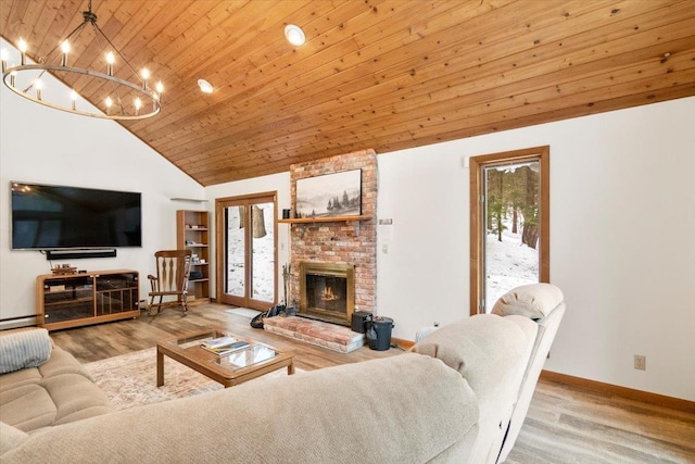 living area with baseboards, wood ceiling, a chandelier, and wood finished floors